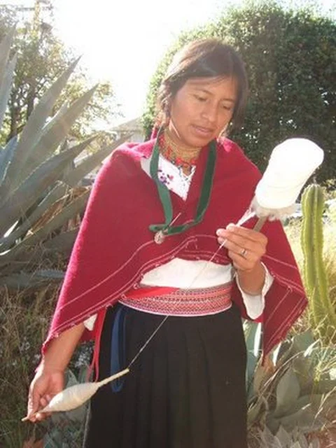 SQ young woman spinning wool thread